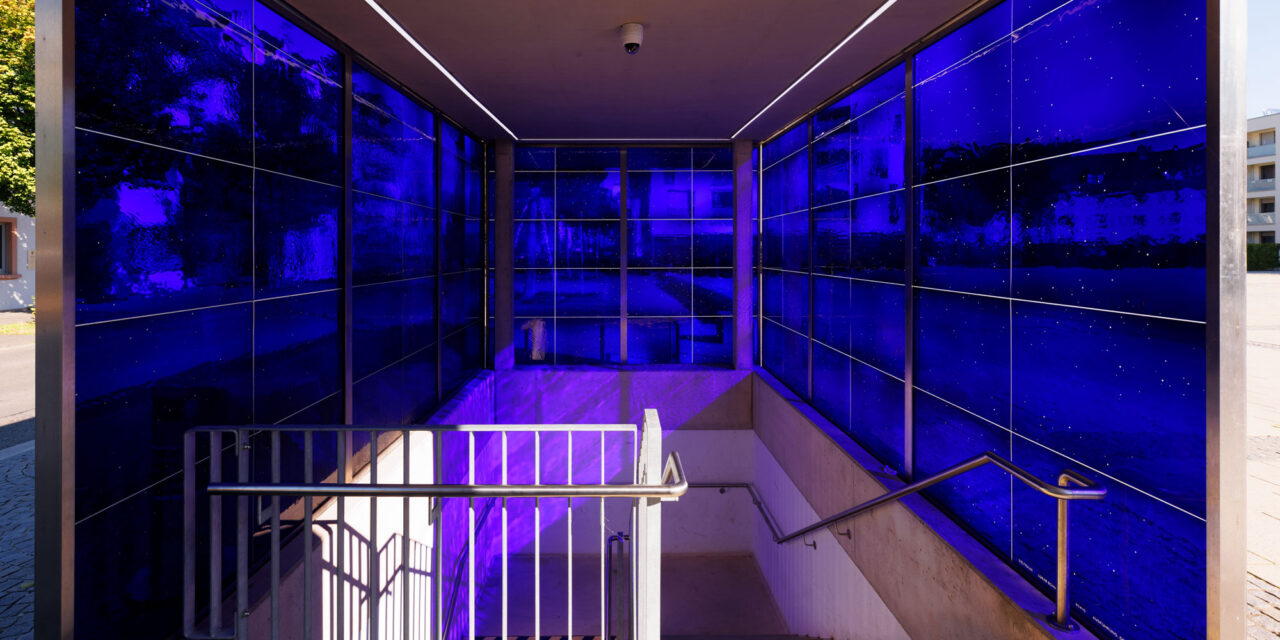 A stairwell enclosed in blue mouth-blown glass.