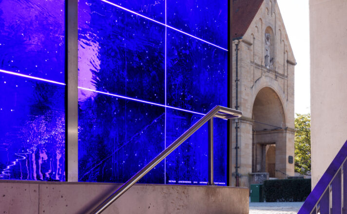 A stairwell enclosed in blue mouth-blown glass.