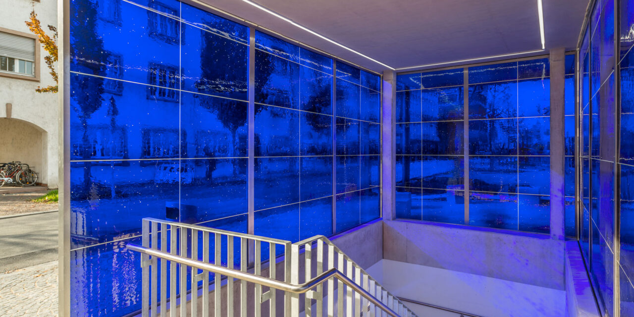 A stairwell enclosed in blue mouth-blown glass.