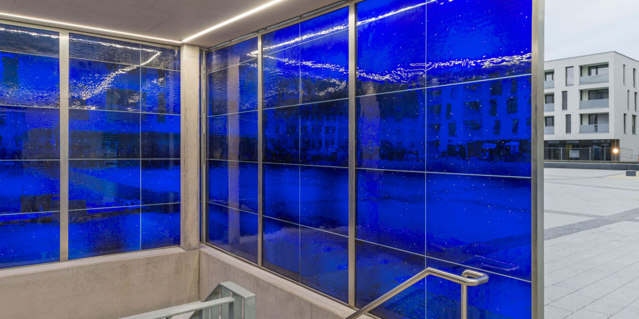 A stairwell enclosed in blue mouth-blown glass.