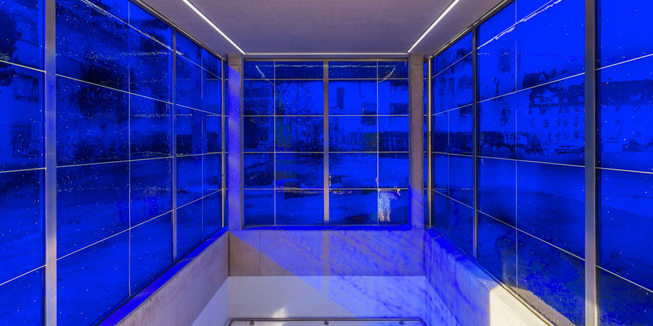 A stairwell enclosed in blue mouth-blown glass.